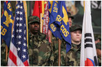 Troops stand at attention Saturday as the President and Mrs. Bush arrive in the Black Cat Hangar at Osan Air Base in Osan, Korea.