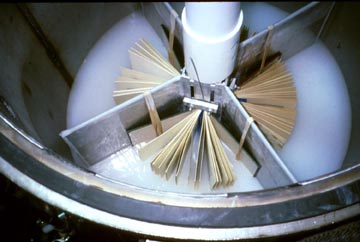 Books are mounted in treatment cylinders, where magnesium oxide is deposited to neutralize acids in the paper.