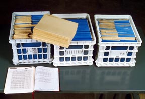 Manuscripts are placed in hanging files to prepare them for treatment.