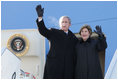 President and Mrs. Bush wave from the top of the steps as they deplane Air Force One Monday, Nov. 21, 2005, in Ulaanbaatar, Mongolia. The stop marks the first time a working U.S. president has visited the country. 