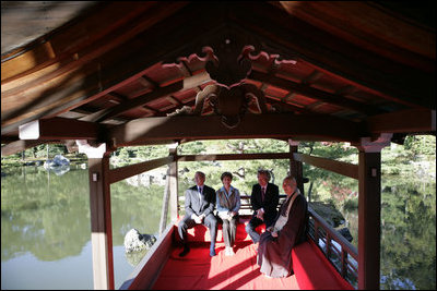 President George W. Bush, Mrs. Bush, Japan's Prime Minister Junichiro Koizumi and the Reverend Raitei Arima, Chief Priest of the Golden Pavilion Kinkakuji Temple, share a light moment during a cultural visit to the temple Wednesday, Nov. 16, 2005, in Kyoto.