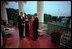 Mexican President Vicente Fox and his wife Martha Sahagun de Fox talk privately with President Bush and First Lady Laura Bush on the Truman Balcony of the White House before greeting guests at the state dinner Wednesday evening. After the dinner, the two couples and their friends watched fireworks from the balcony.