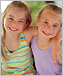 photo of two young girls smiling