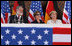 Mrs. Laura Bush is seated between Stralsund Mayor Harald Lastovka and German Chancellor Angela Merkel during the welcoming ceremony Thursday, July 13, 2006, in honor of the visit by President George W. Bush and Laura Bush to Stralsund, Germany.