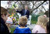 Commerce Secretary Carlos Gutierrez reads from the children's book, "Duck on a Bike," by David Shannon Monday, April 9, 2007, during the 2007 White House Easter Egg Roll on the South Lawn. White House photo by David Bohrer