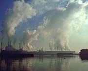 Carbon dioxide and gases from large factories may contribute to global warming.