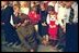 Laura Bush jokes with some children of embassy employees at the American Center in Vilnius, Lithuania Saturday, November 23, 2002.