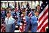 Members of the American Legion hold flags during a Veterans Day ceremony at Arlington National Cemetery in Arlington, Va., Nov. 11, 2002. "This is a place of national mourning and national memory," said the President. "We remember those who served America by fighting and dying on the field of battle. And we remember those veterans who lived on for many decades to serve America in many ways."