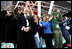 Laura Bush, her daughter, Barbara, and members of the U.S. Olympic Delegation, cheer on American Speed Skater Chad Hedrick Saturday, Feb. 11, 2006, during his heat at the 2006 U.S. Winter Olympics, in Turin, Italy. Hedrick went on to win the first gold medal for the United States.