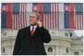 President George Bush listens to Slovak Prime Minister Mikulas Dzurinda's introduction before giving remarks at Hviezdoslavovo Square in Bratislava, Slovakia, Feb. 24, 2005.