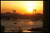 The sun sets over Busan's Gwangan Grand Bridge Friday, Nov. 18, 2005.