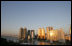 The moon sits over the Gwangan Grand Bridge and the city of Busan, Korea, sight of the 2005 APEC summit.