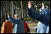 President George W. Bush waves to the crowd after joining his fellow APEC leaders for an official photograph Saturday, Nov. 19, 2005, at the Nurimaru APEC House in Busan, Korea.