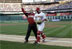 President George W. Bush acknowledges the crowd as he leaves the field with Brian Schneider after throwing the ceremonial first pitch to the Washington Nationals catcher to open the team's inaugural night at RFK Stadium.