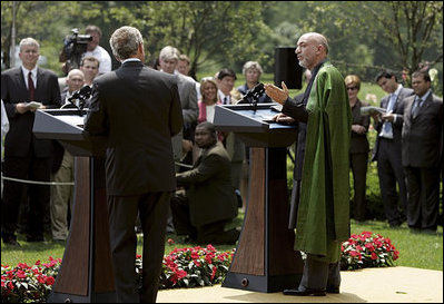 President George W. Bush and Hamid Karzai of Afghanistan hold a joint press conference in the Rose Garden Tuesday, June 15, 2004.