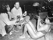 Per Host (center) tape recording a Chaco Indian flutist at the home of Gajego (left), a Chaco medicine man, for the Archive of Folk Culture, 1949. 