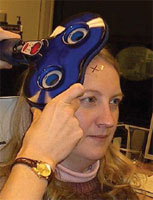 A TMS coil is held over a specific area of the brain to stimulate the underlying neurons. The woman in the photo was a student of Dr. Pape's. The woman in the photo was a student of Dr. Pape's.