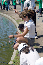 Photograph: Volunteer helps kids untangle their lines.  Fishing on the Washington DC mall.