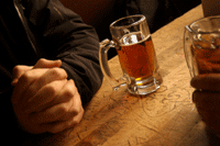 Picture of a mug of beer sitting on a bar.