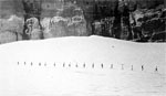 People walking across a glacier