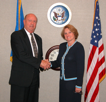 Fred E. Gantzler and Cari M. Dominguez, Chair shake hands after signing contract