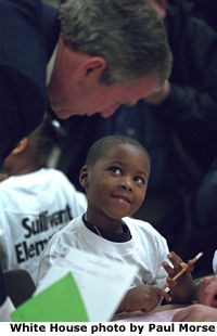 Photo of President Bush with a child. White House photo by Paul Morse