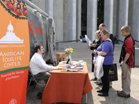 Potential participants sign up to share their stories at the StoryCorps booth on the Library's Madison plaza.
