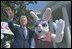 President Clinton poses on stage with the Easter Bunny at the start of the 2000 Easter Egg Roll. The White House Easter Bunny, usually a White House staffer dressed in a special White House rabbit suit, was introduced by Pat Nixon, wife of President Richard Nixon, in 1969.