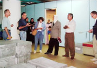 Haley, Albin and Deeb see that manuscripts from the House of Manuscripts are safe in aluminum cases in a neighborhood bomb shelter guarded by ululating women and guards hired by the neighbors. At Deeb's left is Dhamia Abbas Samarai, the director of the House of Manuscripts.