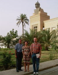 The Library of Congress team, from left, Michael Albin, Mary-Jane Deeb and Alan Haley, report findings every afternoon to an advisor to the CPA's Ministry of Culture housed in Saddam Hussein's Republican Palace, now CPA headquarters and home to 3,000 U.S. troops. The seven-ton head atop the column is of Hussein; four of these heads came down Dec. 2.