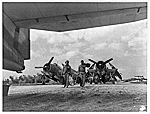 Crew Members of a Marine Torpedo Squadron Lugging Their Own Bags Across the Okinawa Airstrip