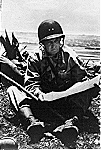 Major General Lemuel C. Shepherd, Seated on Shore, Studying Map of Okinawa