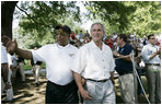 Baseball legend and hall of famer Willie Mays walks with President George W. Bush as he acknowledges a standing ovation from the crowd Sunday, July 30, 2006, upon their arrival for the Tee Ball on the South Lawn game between the Thurmont Little League Civitan Club of Frederick Challengers of Thurmont, Md., and the Shady Spring Little League Challenger Braves of Shady Spring, W. Va. Mays was the honorary Tee Ball Commissioner for the game. 