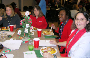 Like other “local” events, the Nottingham party is a potluck paradise. From left to right, Jennifer Collins, Kelly Powell, Fran Cowans and Tammy Baynor enjoy the holiday fare. 