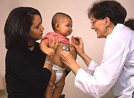 Doctor and baby with parent