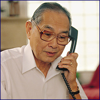 Elderly Asian man on the phone