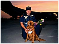 Photo of a firefighter and a dog.