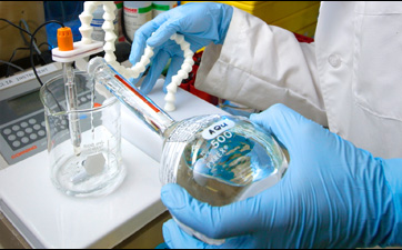 This close-up photograph shows Jason Tully, a CDC laboratorian, using the pH meter in order to prepare a buffer solution in the Personal Care Products Laboratory (PCPL) located in the CDC’s Chamblee, Georgia facilities