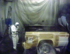 image of worker spraying base coat with protective equipment