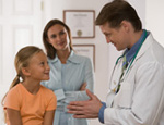 Doctor talking to girl and her mother