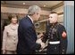 President George W. Bush shakes the hand of Marine Cpl. Andrew L. Tinsley of Annapolis, Md., Wednesday, Dec. 21, 2005, after Cpl Tinsley was presented the Purple Heart during a visit by the President and Laura Bush to the National Naval Medical Center in Bethesda, Md.  White House photo by Paul Morse