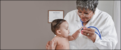 An infant with a healthcare professional