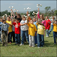 A fourth grade group from Tipton Elementary School in Tipton, Oklahoma try out their anemometers that were made as one of the hand-on activities during Earth Day festivities at Blue Canyon Wind Farm.