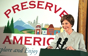 Laura Bush stands at a podium with the Preserve America logo behind her. (Photo: Susan Sterner, White House)
