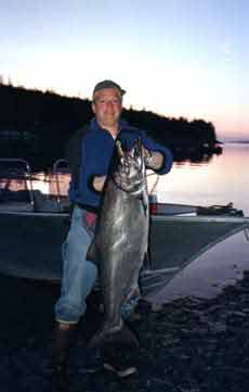 Successful fisherman with a large king salmon.