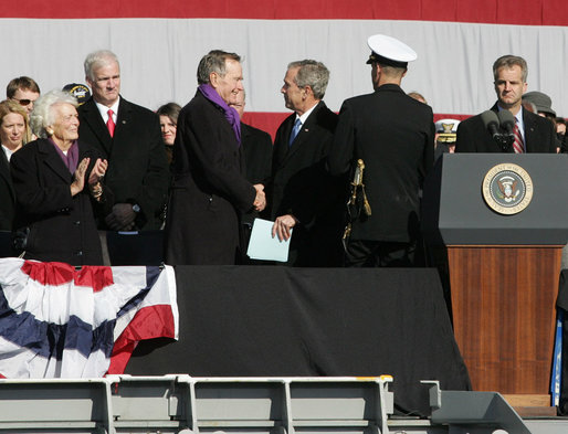 President George W. Bush shakes hands with his father, former President George H.W. Bush following President Bush's remarks in honor of his father at the commissioning ceremony of the USS George H.W. Bush (CVN 77) aircraft carrier Saturday, Jan 10, 2009 in Norfolk, Va. White House photo by Joyce N. Boghosian