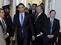 President-elect Barack Obama, accompanied by National Economic Council Director-designate Lawrence Summers, leaves a Democratic policy luncheon on Capitol Hill, 13 Jan. 2009