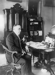 William McKinley, full-length portrait, seated at desk, facing right, June 7, 1898