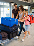 Family walking through airport with luggage