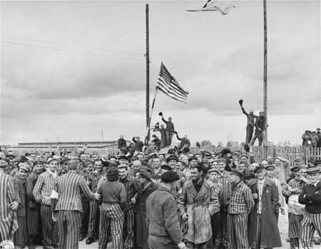 U.S. Seventh Army troops with liberated inmates at a subcamp of Dachau.
